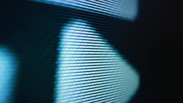 CU, macro shot: changing colorful pictures on LCD screen of modern TV with glowing pixels in room extreme closeup