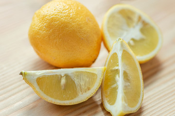 Ripe sliced lemon  on the wooden background. Natural and tasty cold remedies