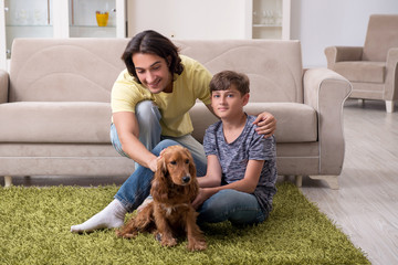Young father and his son with cocker spaniel dog