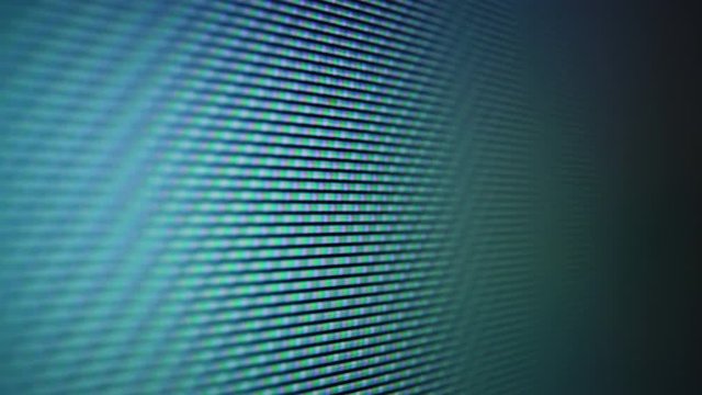 Macro shot: changing green blue colors and pictures on LCD screen of modern TV with different glowing pixels extreme closeup