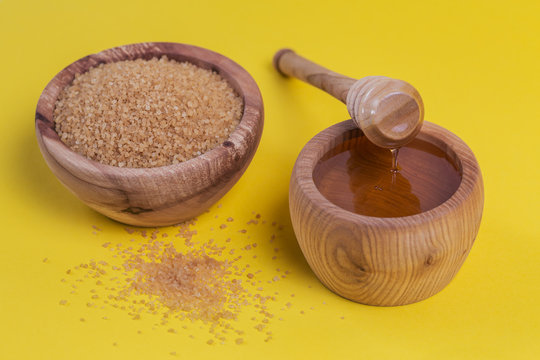 Ingredients For Make Homemade Sugaring Paste. Brown Sugar And Honey On Yellow Background