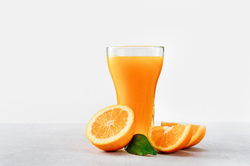 Glass of fresh orange juice with oranges isolated on white