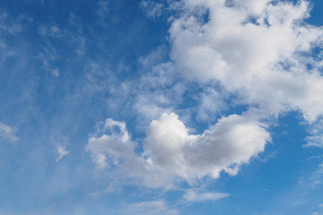 Naklejka na ściany i meble Cumulus clouds on blue sunny spring sky, nature background.