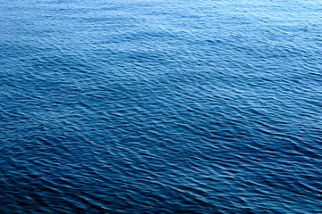 Obraz premium Gradient blue abstract background with the sea water surface on the windy day