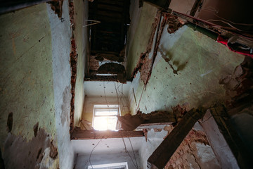 Fototapeta na wymiar Interior of the ruined collapsed abandoned house