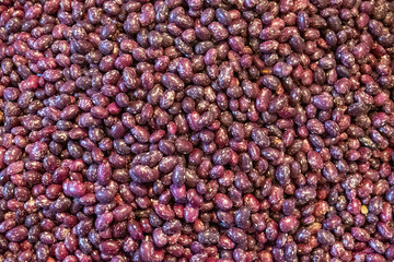 Different types of beans in a box. Legumes, multi-colored grains. Red, white, colorful fruits. Selling a crop in the market. Natural, healthy, vitamin-rich foods. Food for health.
