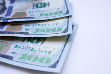 One hundred dollar bills on white background