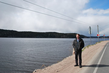 man stands on a stone dirt road.