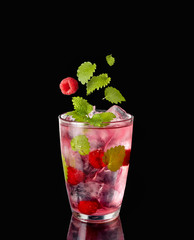 A glass with ice-cold infused water with raspberry
