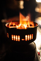 hot red coals with hookah sparks in metal bowl for Shisha Smoking Coal for hookah close-up  hot red coals for hookah in Cup close up