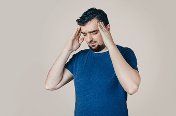 Men in the t-shirt holding hands to his head. Health problems