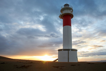 Lighthouse Fangar, in Tarragona, Spain, at sunset