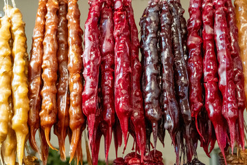 National Georgian Sweet Churchkhela. Composed of nuts and natural grape syrup. Selling crops on the market. Natural, healthy, vitamin-rich foods. Food for health.