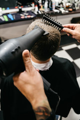 Fototapeta na wymiar hairdresser makes styling for man, businessman