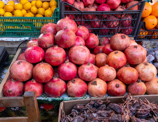 Red pomegranate in a box. Selling crops on the market. Natural, healthy, vitamin-rich foods. Food for health.