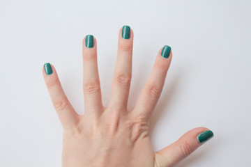  beautiful dark green nail polish female manicure. spa concept, minimalism. Top view
