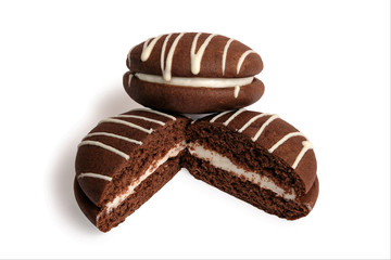 Two halves chocolate whoopies pies with marshmallow filling isolated