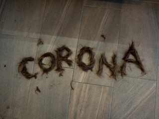 Corona lettering made of hair to illustrate the upcoming problems of hairdressers