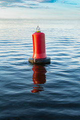 Warning red buoy in the ocean