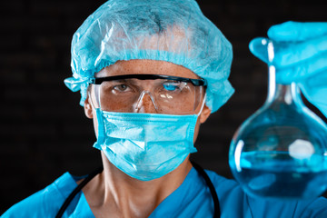 Experienced virologist with glasses and a mask