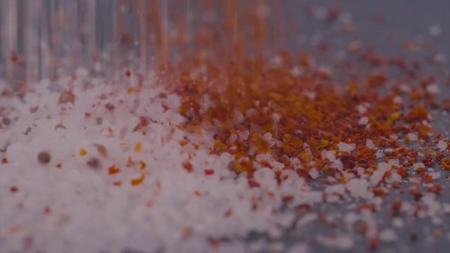 coarse salt and paprika sprinkle on a black surface