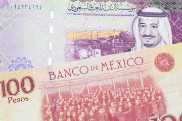 A one hundred Mexican peso bill, shot in macro with a five Saudi riyal bank note from Saudi Arabia