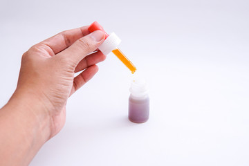 dripping the vaccine using a medical pipette isolated white background
