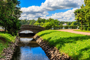 Stone arch bridge across a small river in Catherine park in Pushkin (Tsarskoye Selo), Russia