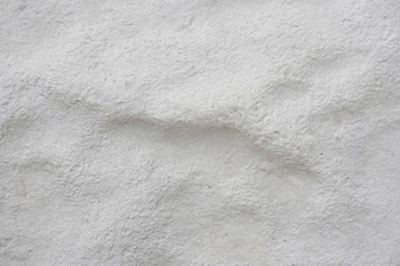 Bumpy concrete cement surface. Rough light gray building block. Background or wallpaper. Reduced contrast. Construction and repair of buildings