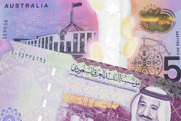 A close up image of a purple, five Australian dollar note close up, in macro with a five riyal note from Saudi Arabia