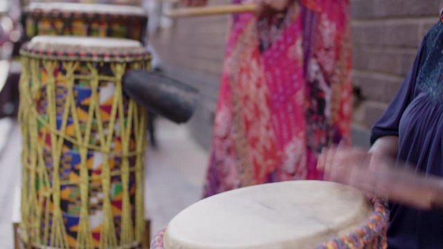 Two black african women playing traditional drums at a crafts market in Johannesburg, South Africa. 