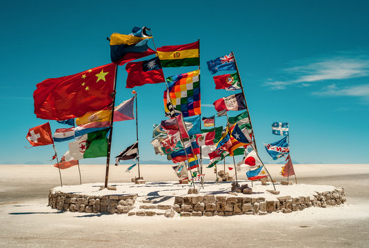 Several Flags from around the World Flying in the Wind in the World's Largest Salt Desert in Uyuni, Potosi / Bolivia