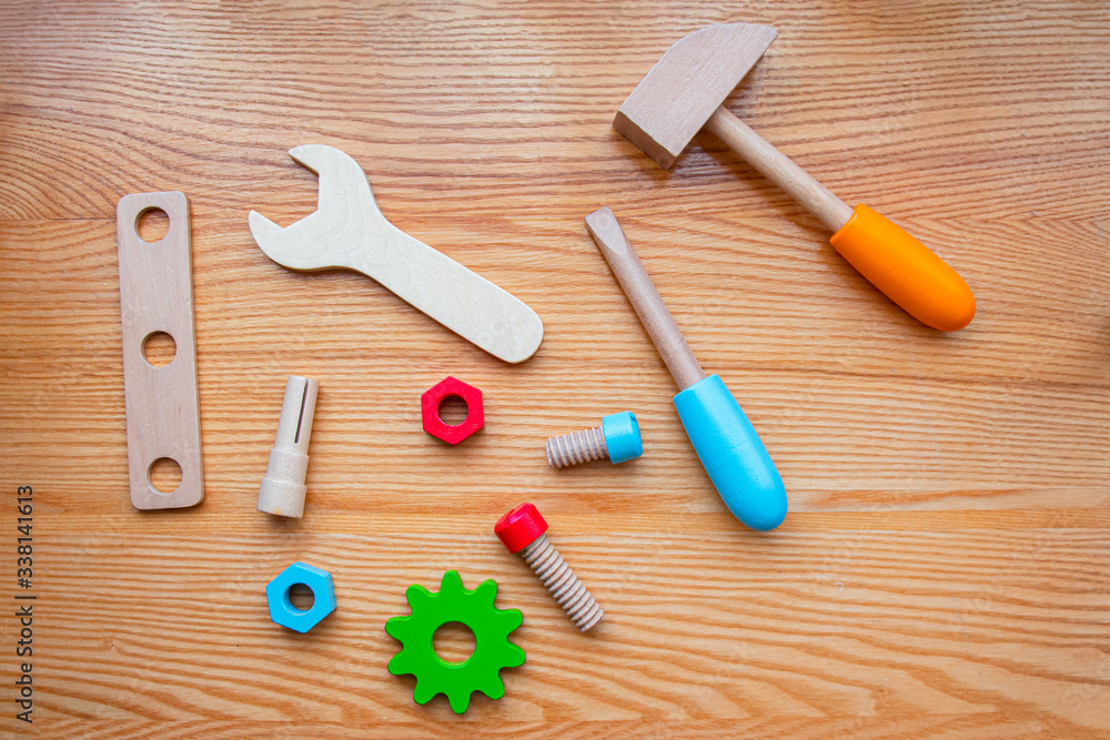 Wall mural wooden children toy tools lie on the wood table