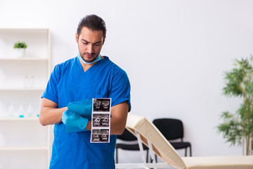 Fototapeta premium Young male doctor working in the clinic