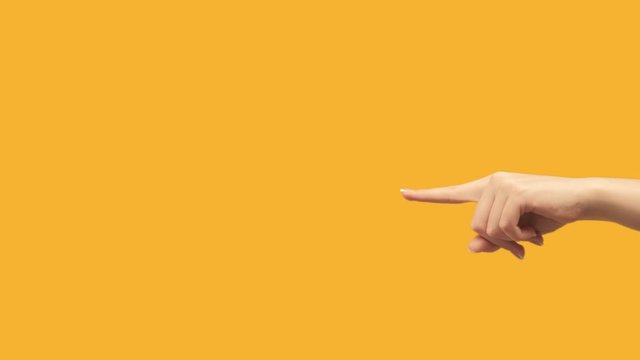 Hand signal. Commercial background. Female finger showing empty space for logo isolated on orange.