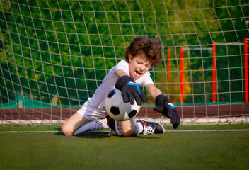 Summer soccer tournament for young kids. football club. emotions and joy of the game. Young goalie....