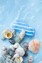Soap with seashells and stones on a sea background

