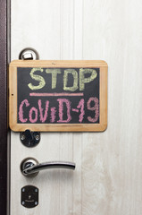 Stop COVID-19 text on the chalkboard