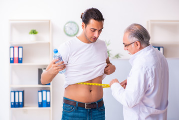 Doctor dietician giving advices to fat overweight patient