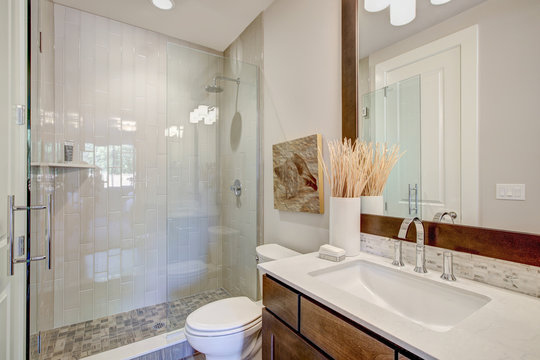 White and brown bathroom interior. Luxury American modern home.