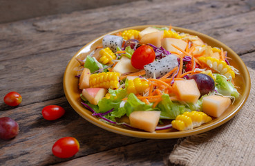 Fruits salad and vegetable in dish plate on wooden
