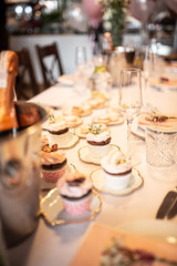 Beautiful table set for an event party or wedding reception . restaurant interior cakes on table