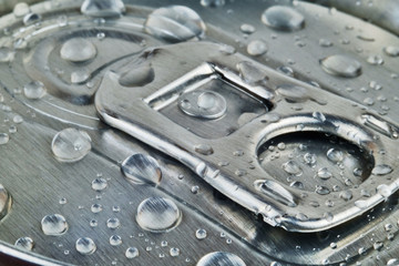 Top of metallic shiny drink can with water drops