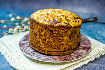 Tasty easter cake with almond flakes on a dark background, next to a pussy-willow twig. The concept of Easter baking for the holiday, copy space