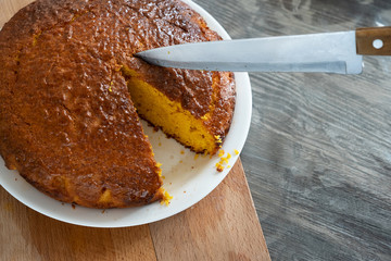 Carrot cake and knife on a wooden table.
