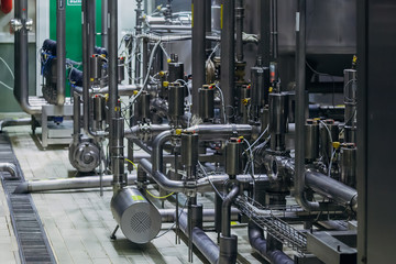 Industrial steel vats connected by pipeline