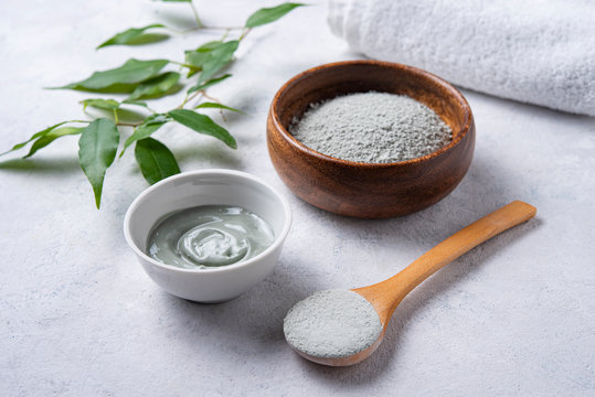 Mask Made Of Cosmetic Green Clay At Home In A Wood Bowl On A Gray Concrete Background