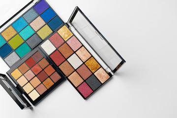 Make up colorful eyeshadow palettes isolated on white, top view