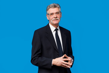 Stylish and fashion bearded man in suit and tie isolated on blue background. Business style, and...