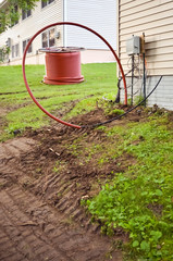 Spool of Cable and Buried Cable Connecting to a Building